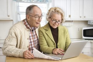 Senior couple working on laptop computer